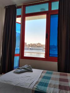 a bedroom with a window looking out at the ocean at New El Amin Guesthouse in Aswan