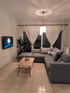 a living room with a couch and a table at Lovemade central apartment in Kos Town