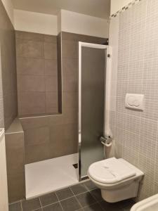 a bathroom with a shower and a toilet in it at Garda Smile in Riva del Garda +30 photos