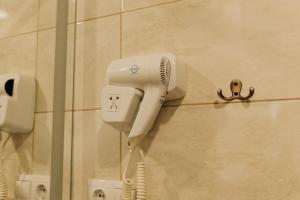 a hair dryer on a wall in a bathroom at SeaLine Apart-Hotel in Odesa +31 photos