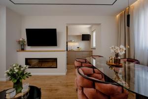 a living room with a table and a fireplace at Labin Home in Labin