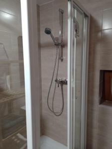 a shower with a shower head in a bathroom at Studio Pohoda Na Razcesti Cingov Slovensky Raj in Spišské Tomášovce