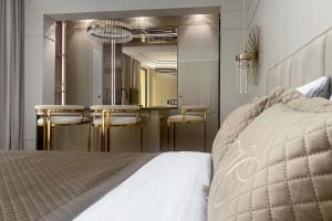 a bedroom with a bed and a bathroom with a mirror at Monaco Premium Suites in Monte Carlo