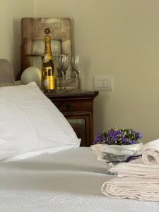 a bed with a bottle of champagne and two wine glasses at Casa Alba, Blevio Lago di Como in Blevio +21 photos