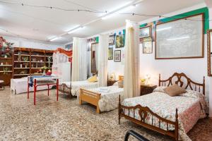a bedroom with two beds and a table at Hostel Venta in Lorca +20 photos