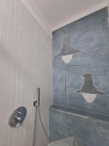 a bathroom with a toilet with two top hats on the wall at PHI-Lampara in Santa Flavia