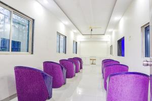 a row of purple chairs in a room at Via Classic Square I in Pune