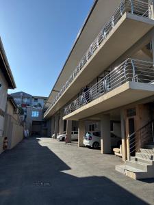 a building with a parking lot with cars parked at Crompton Studio Apartment 786 in Durban