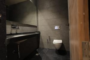 a bathroom with a sink and a toilet at Hotel Black Harbour - A Unit of Om Shanti Inn in Bharatpur