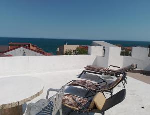 two chairs and a table on top of a building at Samaya in Eforie Nord