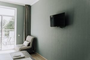 a living room with a tv on a wall at SeaLine Apart-Hotel in Odesa