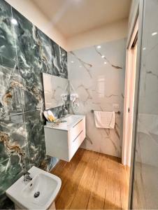 a bathroom with a sink and a mirror at Villa Perla Del Mare in Mondragone