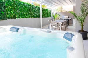 a jacuzzi tub in a patio with a table at Beautiful 3BR w Private Jacuzzi by Arco Collection in Is-Swieqi