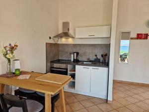 a kitchen with a table and a stove top oven at Casa Luma in Poljana +28 photos