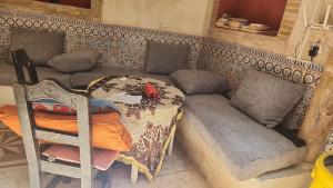a living room with a couch and a table at Hostel & Riad in Essaouira +39 photos