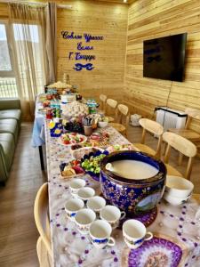 a long table with cups and plates of food at Bright Terelj Family Camp in Dugang Süme