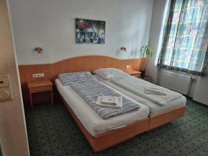 a bed in a room with two nightstands at Aparthotel Mariazellerhof in Sankt Pölten