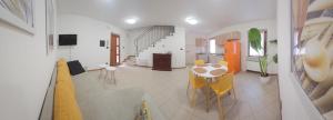 a kitchen and dining room with a table and chairs at Ai Gelsi in Mortegliano
