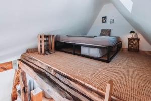 a bedroom with a bed in the attic at Das Alte Pfarrhaus Galerie in Gleisweiler