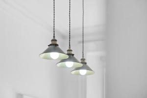 a group of three lights hanging from a ceiling at Steeple View Apartment - Cosy 1 bed in Montrose in Montrose