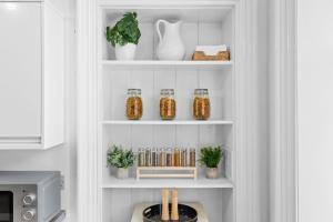 a shelf with jars and plants in a kitchen at Steeple View Apartment - Cosy 1 bed in Montrose in Montrose +24 photos