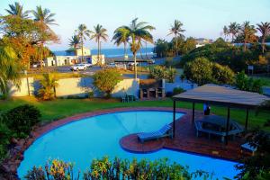 an overhead view of a swimming pool with a gazebo at The Waves Beachfront Stay - Gleneagles in Ballito