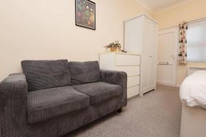 a living room with a couch and a bedroom at Chic Bath Flat for Couples with Free Parking! in Bath