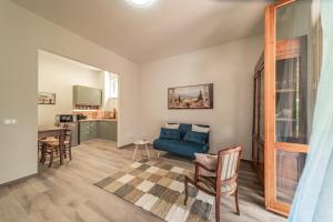 a living room with a blue couch and a table at The Olive Suite in Cerbaia