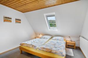 a bedroom with a bed and a window at Winzerhof Bitzenhofer in Vogtsburg