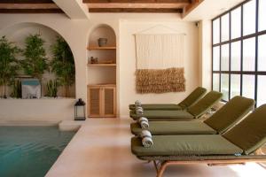 a living room with chairs and a swimming pool at Nomad Boutique Resort Benidorm in Benidorm +29 photos
