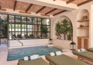 a swimming pool in a house with windows at Nomad Hotel Cala Finestrat in Benidorm