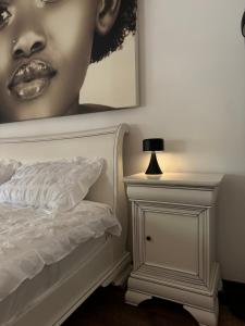 a bedroom with a bed and a picture of a woman at Jazz Residence in Piatra Neamţ +9 photos