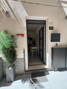 a house with a door open to a patio with a table at Marea Apartment's in Letojanni