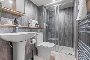 a bathroom with a toilet sink and a shower at Stylish Flat in Central Leeds with Mezzanine Room Sleeps 4 by PureStay in Central Station