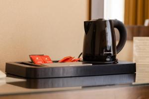 a coffee pot sitting on top of a counter at Hotel Clermont in Covasna