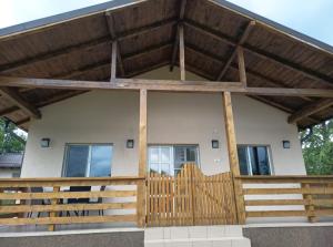 a house with a wooden gate and a fence at Garden Chalet in Câmpulung +2 photos