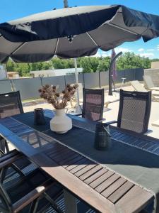 a table with a blue table cloth and an umbrella at Melanie in Mazurija