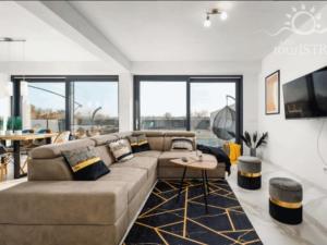 a living room with a couch and a tv at Melanie in Mazurija