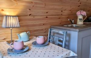 a table with two cups and a lamp and a sink at Meadow Lane in Sligo