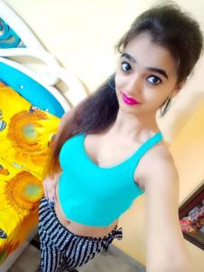 a woman in a green dress standing next to a surfboard at Vijay Kumar Pandey in Mysore