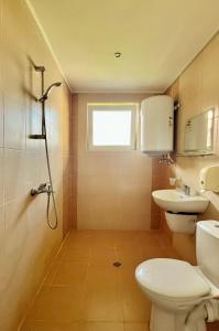 a bathroom with a toilet and a sink and a window at STELA in Nesebar +37 photos