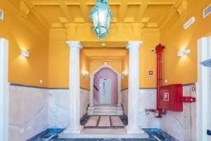 a hallway with a pink door and a ceiling at Boavista 83 Hostel Lisbon in Lisbon