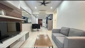 a living room with a couch and a table at ENCORP Marina in Iskandar Puteri