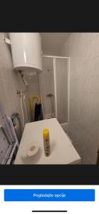 a small bathroom with a toilet and a light at Luksuzni apartman Borna in Pag