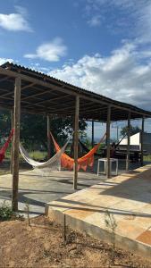 a picnic shelter with hammocks and a bus at Chalés do Abraão in Martins +37 photos