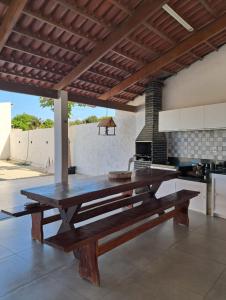 a large wooden dining table in a kitchen at Chalés do Abraão in Martins