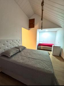 a bedroom with a large bed in a room at Chalés do Abraão in Martins +46 photos