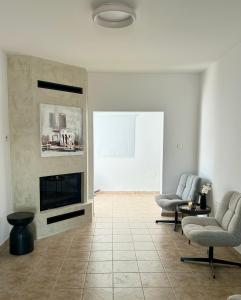 a living room with two chairs and a fireplace at Premium 2025 Housing with BBQ in Paralimni