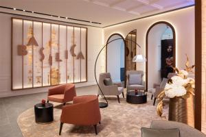 a waiting room with chairs and tables and a lobby at Radisson Collection Hotel, Basilica Budapest in Budapest +82 photos