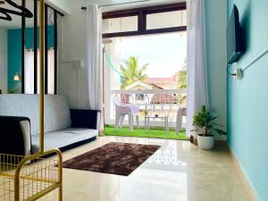 ein Wohnzimmer mit Couch und großem Fenster in der Unterkunft Hidden gem Studio Flat in Colva anirah Wi-Fi in Colva